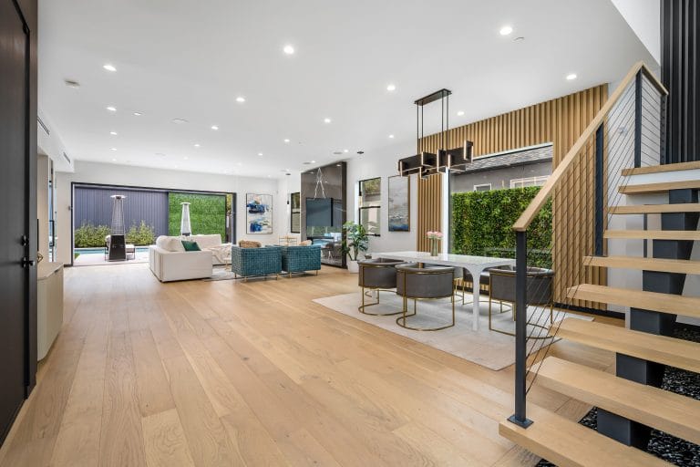 Spacious living room with multiple pieces of furniture on hardwood floors