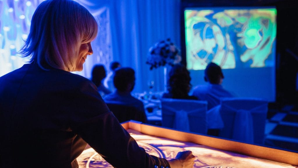 Event 12 the artist paints plot paintings with sand on a lighted table